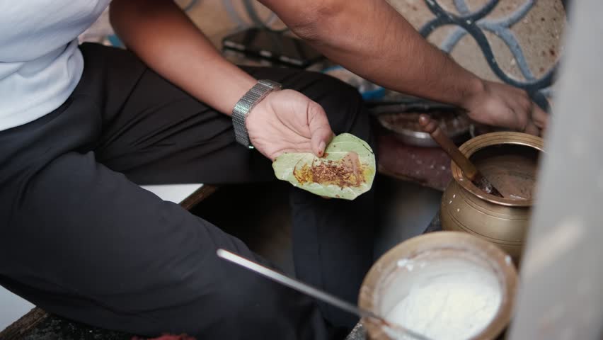 Betel leaves in a street market in Mumbai, India. Traditional Betel Leaf Preparation at an Indian Street Market