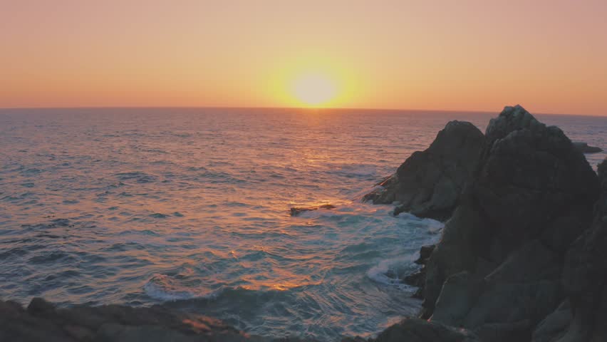 Vibrant Sky During Sunset Over The Pacific Ocean From Baja California Rocky Mountains. - aerial shot