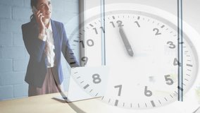 Animation of clock moving over caucasian businesswoman talking on smartphone in office. Business and digital interface concept digitally generated video. - Powered by Shutterstock - Get 15% off with code: PIKWIZARD15