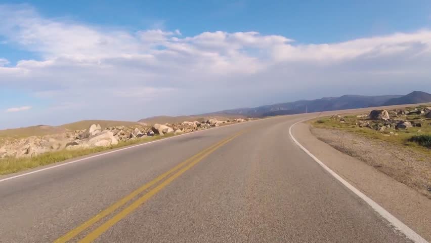 Driving on Beartooth Highway, US Route 212, near the mountain summit in Wyoming, USA