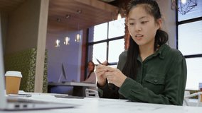 Animation of media icons over asian businesswoman using laptop. Global business and digital interface concept digitally generated video. - Powered by Shutterstock - Get 15% off with code: PIKWIZARD15