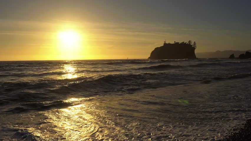 Colorful sunset over Ruby Beach with waves crashing against pebble shoreline in Olympic National Park, Washington state, USA. 4K UHD video.