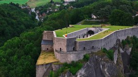Aerial view of the Citadel of Dinant, Belgium, with its Belgian flag waving in the wind. Tourists visit the historical fortress - Powered by Shutterstock - Get 15% off with code: PIKWIZARD15