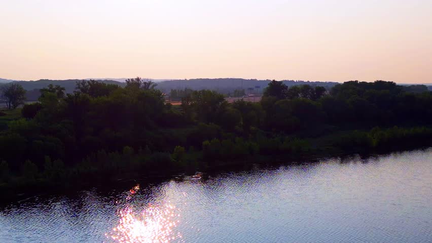 a shifting aerial view of a lake and the surrounding landscape