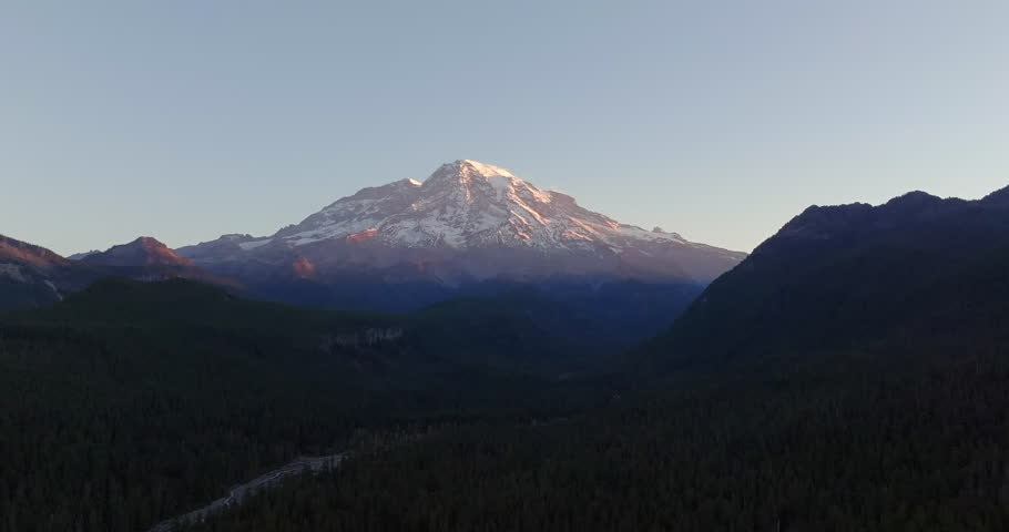 Dawn View of Mount Rainier with Snowy Peaks and Forested Valleys in Soft Morning Light