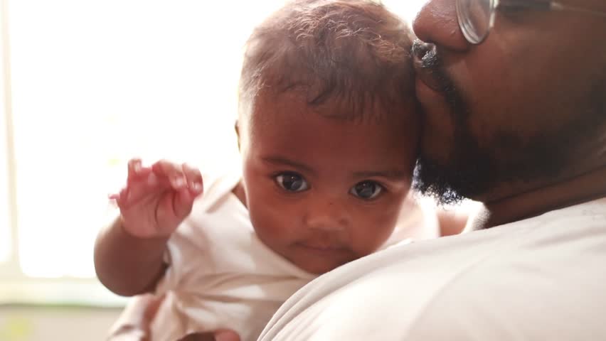 Father, crying baby and comfort, kiss and care, love and bonding in family home together. Dad, sad infant and parent support newborn, holding frustrated young kid and calm child, stress and console