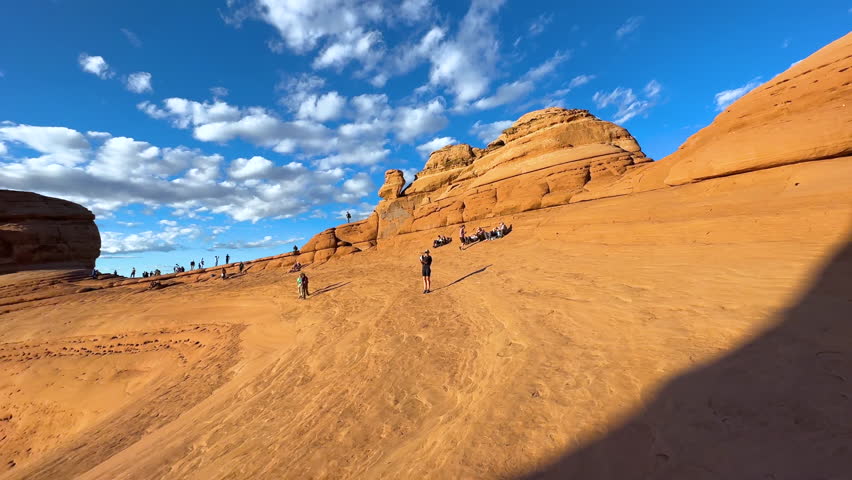 Delicate Arch adventure tourist travellers exploring Arches National Park Utah sunset travel tourism America