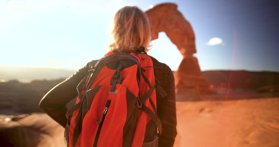 Delicate Arch female traveller natural rock formations Landscape Arches National Park Utah sunset travel tourism America