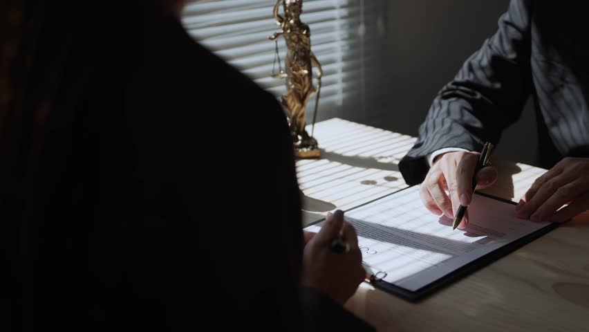 Lawyer highlighting key points while clarifying contract terms for a client in a professional office. Important discussions foster understanding and ensure informed decisions before signing