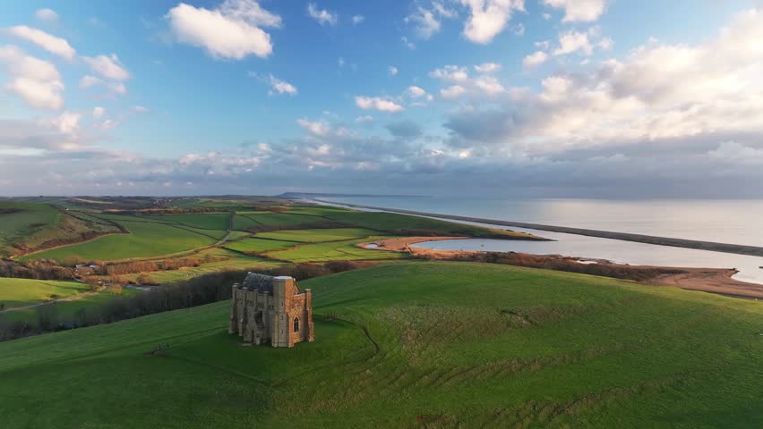 Aerial clip of St. Catherine's Chapel overlooking Chesil Beach, Abbotsbury, Dorset, England, United Kingdom, Europe
