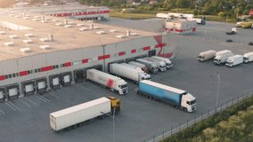 Aerial Sunset View: Massive Logistics Complex | Trucks at Warehouse Loading Docks | Summer Distribution Terminal Operations | Freight Sorting Hub | Supply Chain Infrastructure - Powered by Shutterstock - Get 15% off with code: PIKWIZARD15