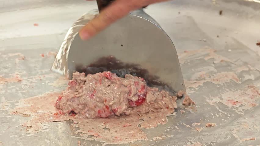 Stir-fried ice cream rolls at freeze pan. Hand made ice cream dessert.