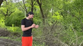 Young sportsman checking performance metrics on a smartwatch while running along a scenic countryside path - Powered by Shutterstock - Get 15% off with code: PIKWIZARD15