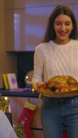 Beautiful caucasian family of five members gathering on Christmas Eve eating and enjoying dinner communicating sharing love moments together. Reunion. Winter time.
