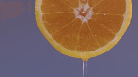 Water drips flowing from a sliced sweet and fresh orange down on a grey background, fruit for frash and natural juice, cold diet drink with vitamin c. Slow motion, filmed on cinema camera, 4K. - Powered by Shutterstock - Get 15% off with code: PIKWIZARD15