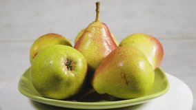 Ripe pears with water drops on green plate. - Powered by Shutterstock - Get 15% off with code: PIKWIZARD15