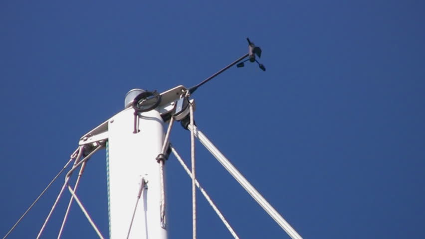 Measuring force of wind on top of the mast sailing big yacht, sunlit