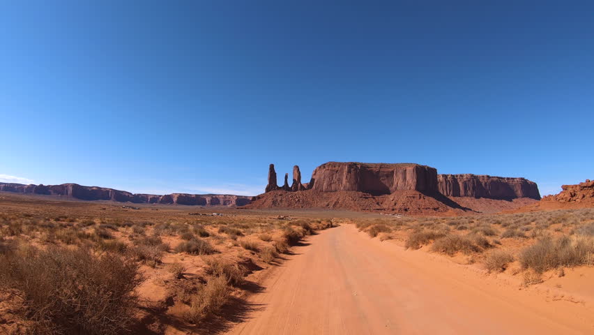 POV desert drive dirt road Monument Valley Navajo Tribal Park famous with travellers Colorado Plateau Utah Arizona