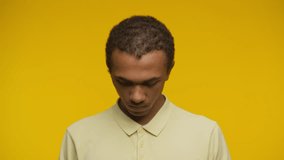 Angry man staring directly at camera on yellow background - Powered by Shutterstock - Get 15% off with code: PIKWIZARD15