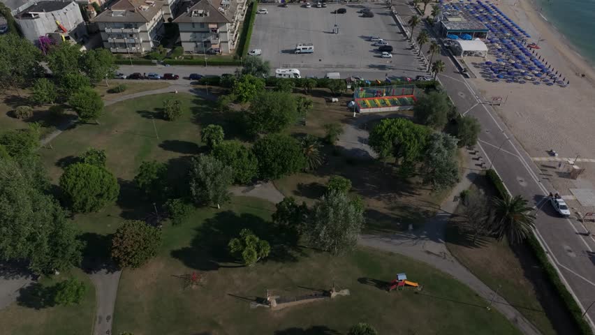 aerial over the beach at Porto Recanati, Europa Park lined with umbrellas, Adriatic Sea, Italy