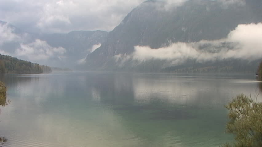 low lying clouds on lake mountain background