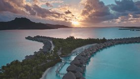 Luxury resort overwater bungalows, Bora Bora, French Polynesia. Amazing colorful sunset sky over hotel luxury villas coral reef lagoon. Wild nature paradise, exotic summer travel. Aerial drone flight - Powered by Shutterstock - Get 15% off with code: PIKWIZARD15