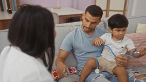 Father and son playing with a stethoscope while woman watches in a home living room showing family interaction in an indoor environment - Powered by Shutterstock - Get 15% off with code: PIKWIZARD15