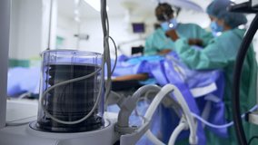 Lung ventilator pump works in the surgery room. Close up. Doctor and scrub nurse operate the patient at backdrop in blur. - Powered by Shutterstock - Get 15% off with code: PIKWIZARD15