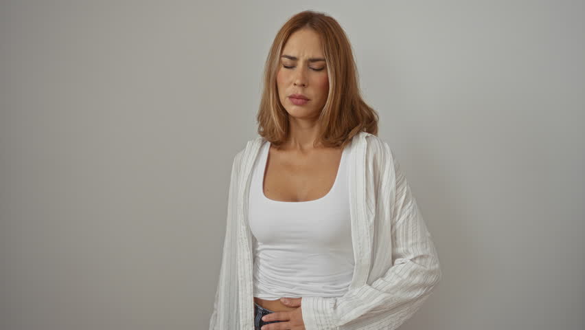 Woman brunette white background young adult isolated feeling unwell holding stomach beautiful female wearing white tank top