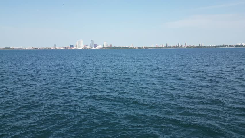 This captivating drone footage captures a stunning aerial view of Lake Michigan, with its expansive blue waters stretching towards the horizon.