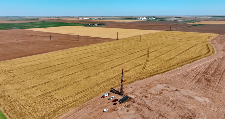 Distancing from the little location with oil production in the vast field. Rising up over the area for drilling natural resources.