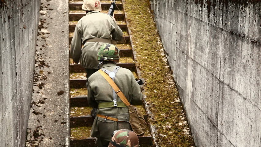 Soldiers running up bunker stairs