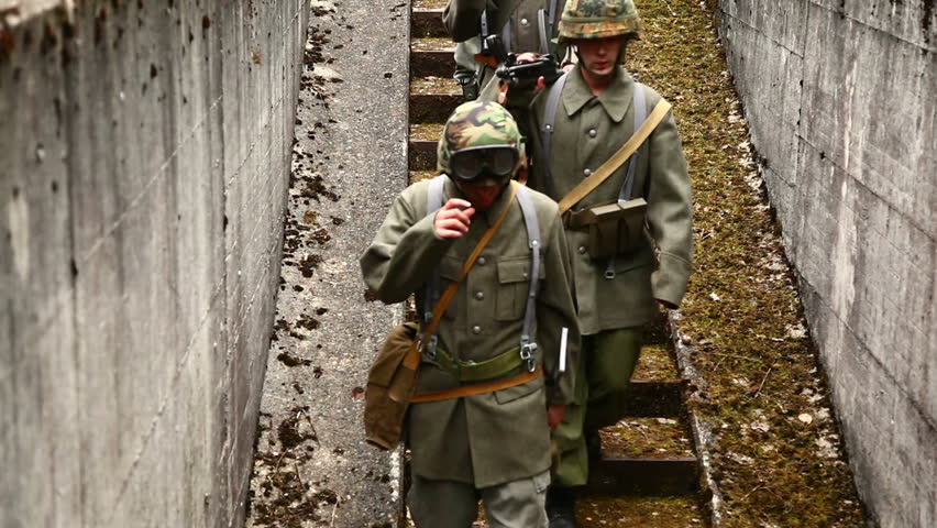Soldiers walking down concrete stairs to bunker