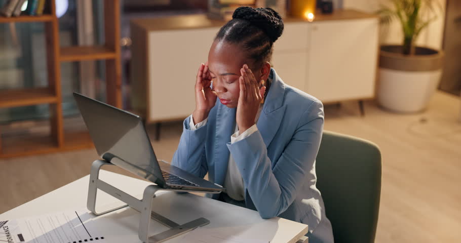 Headache, stress or black woman with pain in office on deadline, burnout or sick of overwork at night. Tired, migraine or massage temples in business for fatigue, mental health or brain fog on laptop