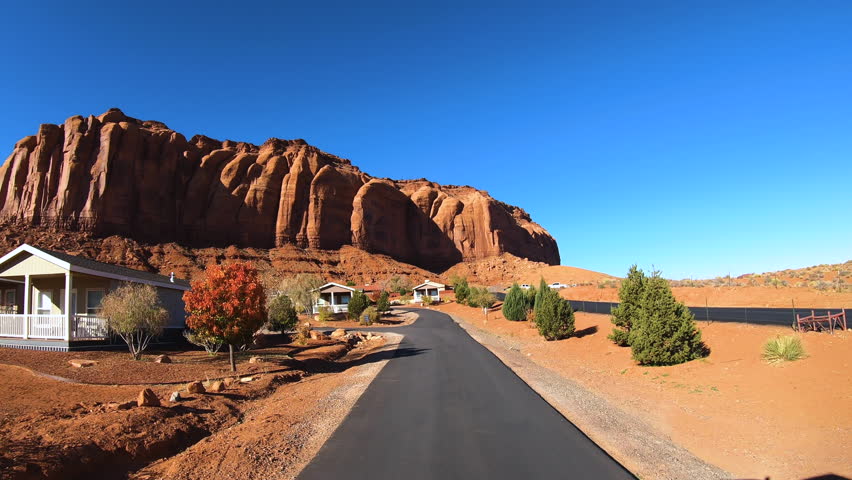 POV drive tourist holiday rental cabins Monument Valley near majestic buttes desert Landscape Utah Arizona USA travel