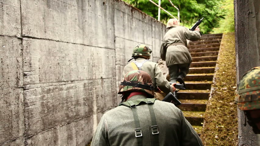 Soldiers running up bunker stairs