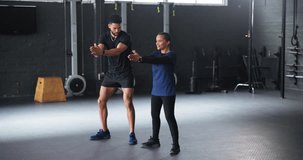 Personal trainer, man and mature woman in gym with squat, support and happy for fitness in retirement. Coach, mentor and senior person with smile, advice and legs to start workout for muscle growth - Powered by Shutterstock - Get 15% off with code: PIKWIZARD15