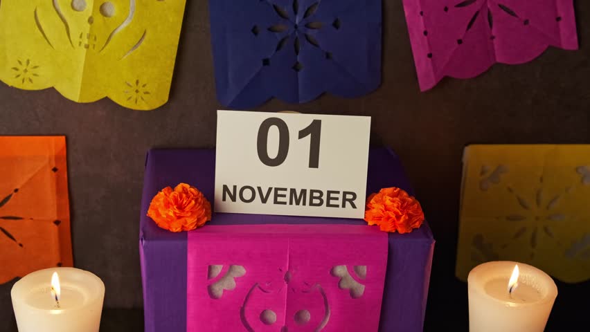 Macro view of a Mexican altar of the dead with all its elements, cempasuchil flowers, fruit, food, bread, water, salt, candles, incense and papel picado