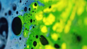Vertical video. Color foam texture. Fizz fluid. Blur neon green yellow blue black color shimmering glitter ink bubbles mix wave motion abstract art background. - Powered by Shutterstock - Get 15% off with code: PIKWIZARD15