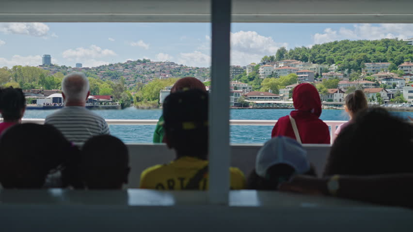 Istanbul, Turkey - 24 AUG 2024 circa: Tourists Riding on a Boat Bosphorus Cruise Tour in Istanbul on Sunny Summer Day. Concept of Travel, Exploring, Vacation, Tourism, Sightseeing, Discovery, Journey