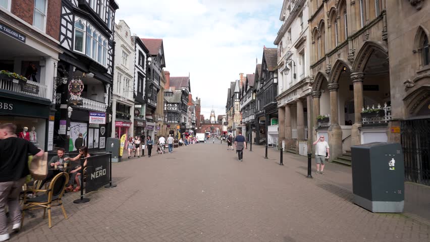 CHESTER, UK - AUGUST 12, 2024: Driving through Chester city centre in 2024 with people and shops