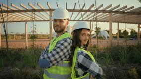 Two proud Caucasian successful workers technician male man guy woman female girl engineers posing together crossing arms cross hands partnership cooperation ecology business construction nature farm - Powered by Shutterstock - Get 15% off with code: PIKWIZARD15