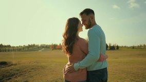 Back view happy Caucasian married couple man woman hugging embrace kissing husband wife celebrating anniversary outside rural meadow park. Love romantic weekend date relaxation ecology nature marriage - Powered by Shutterstock - Get 15% off with code: PIKWIZARD15