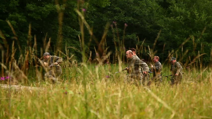 Soldiers running through field