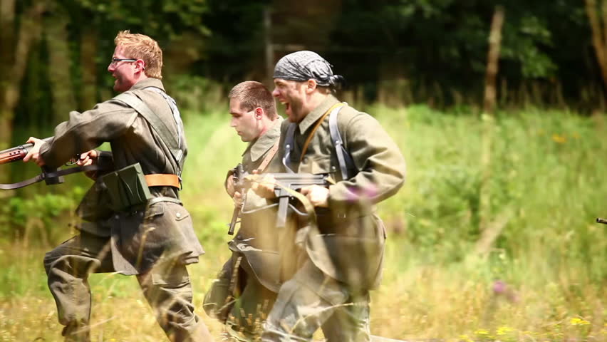 Soldiers running through grass