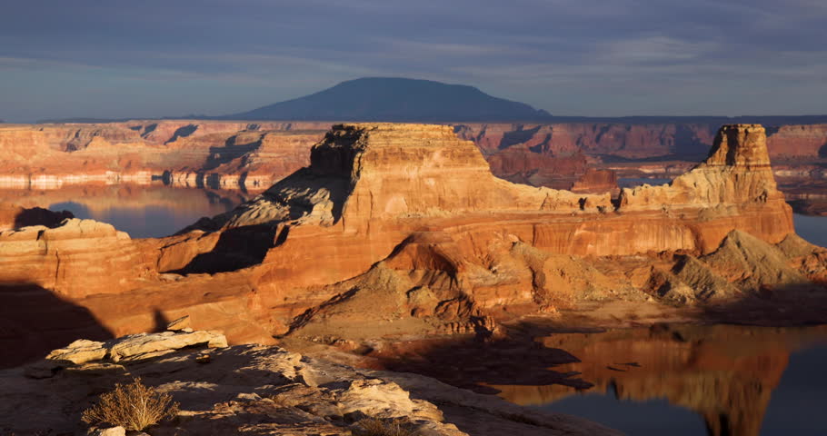 Solo female traveller on American West adventure at dramatic sunset Lake Powell Arizona Canyon USA travel and tourism