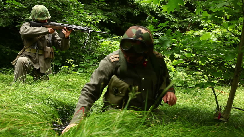 Soldier setting up a trap with a grenade