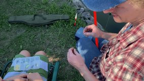 A young father and his son enjoy quality time together, fishing at a pond. The father teaches his son the basics of fishing, creating cherished memories during their outdoor family bonding experience - Powered by Shutterstock - Get 15% off with code: PIKWIZARD15