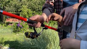 A young father and his son enjoy quality time together, fishing at a pond. The father teaches his son the basics of fishing, creating cherished memories during their outdoor family bonding experience - Powered by Shutterstock - Get 15% off with code: PIKWIZARD15