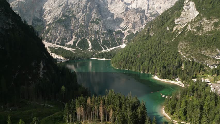 Lake Prags Surrounded By Dolomite Mountains In South Tyrol, Italy. drone tilt-down shot